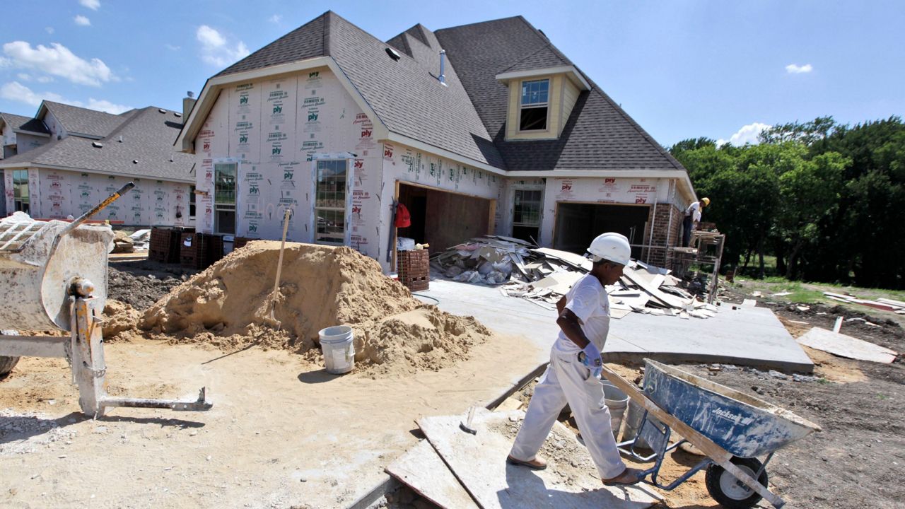 In this Wednesday, June 20, 2012, photo, workers finish up a house under construction in Wylie, Texas. (AP Photo/LM Otero)