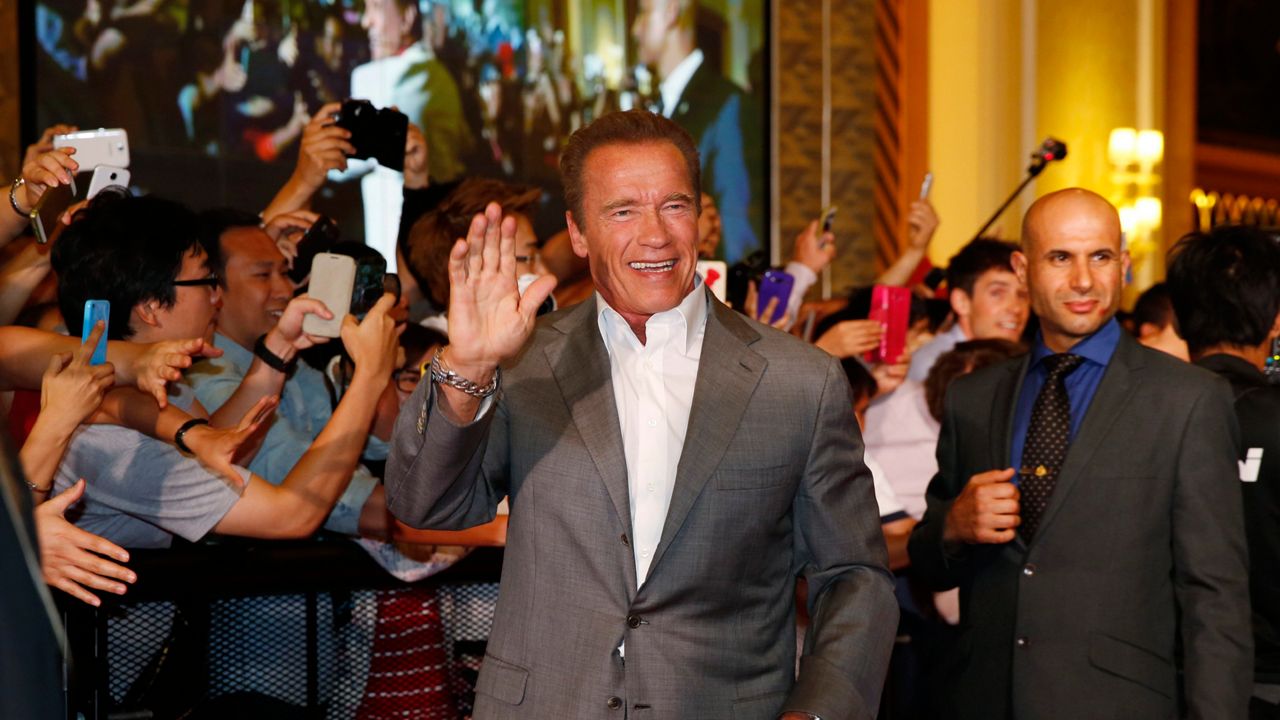 U.S. actor Arnold Schwarzenegger waves on the red carpet for the Macau premiere of his movie "The Expendables 3" in Macau, China, Friday, Aug. 22, 2014. (AP Photo/Kin Cheung)