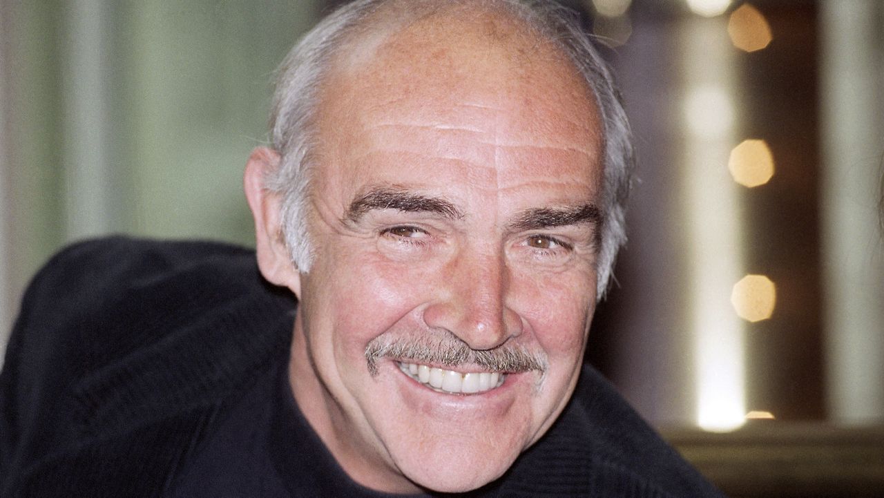 The Scottish actor Sean Connery gives photographers a friendly smile during a press conference in Hamburg, Germany on Wednesday, March 4, 1992. (AP Photo/Christian Eggers)