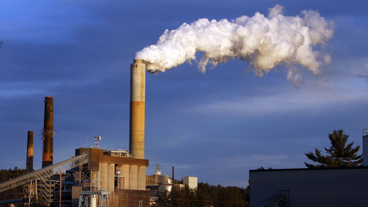 FILE - In this Jan. 20, 2015 file photo, a plume of steam billows from the coal-fired Merrimack Station in Bow, N.H. (AP Photo/Jim Cole, File)
