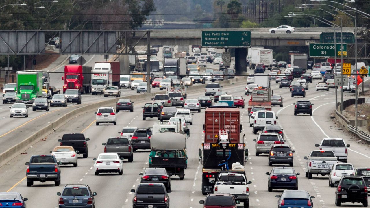 In this Feb. 6, 2014 photo, late morning traffic travels on Interstate 5, in Los Angeles. (AP Photo/Damian Dovarganes)