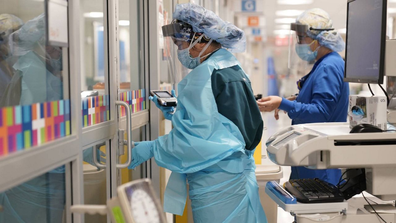 Medical personnel don PPE at Bellevue Hospital in New York. (AP Photo/Seth Wenig)