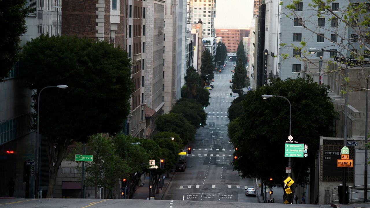 Grand Avenue stands bereft of cars and pedestrians as stay-at-home orders continue in California due to the coronavirus pandemic, Saturday, April 25, 2020, in downtown Los Angeles. (AP Photo/Chris Pizzello)
