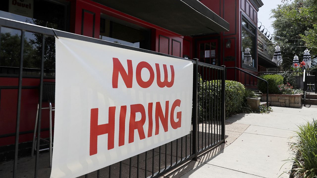 FILE - Sherlock's, a pub in Addison, Texas, has a sign out front that reads, "Now Hiring", Friday, June 26, 2020.  (AP Photo/Tony Gutierrez)(AP Photo/Tony Gutierrez)