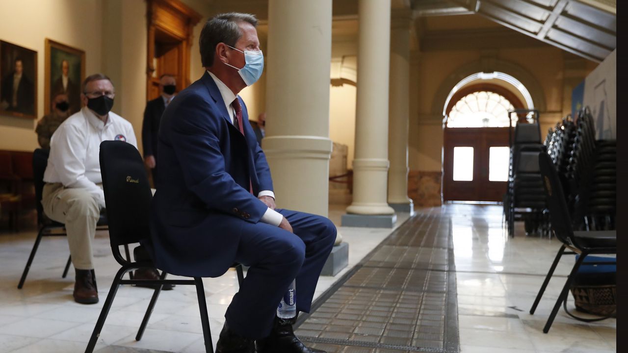 Georgia Gov. Brian Kemp waits to speak during a coronavirus briefing at the Capitol Friday, July 17, 2020, in Atlanta. (AP Photo/John Bazemore)