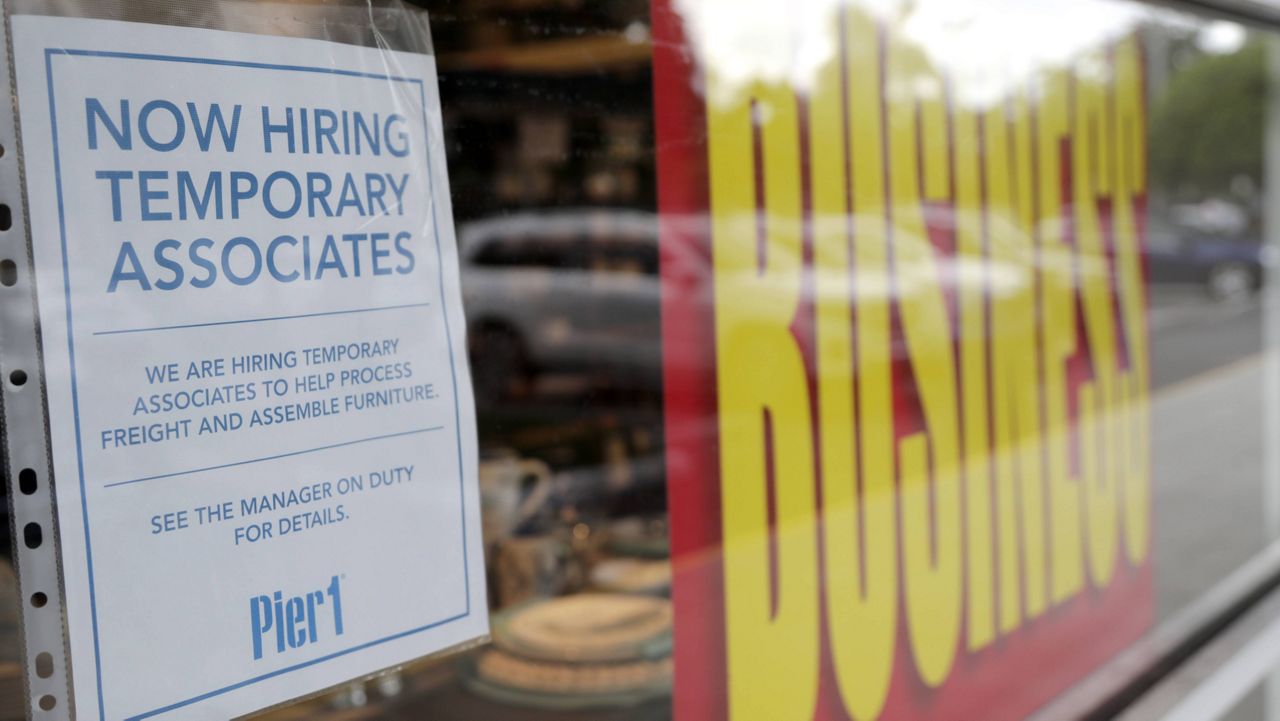 A sign advertises hiring of temporary associates at a Pier 1 retail store, which is going out of business, during the coronavirus pandemic, Thursday, Aug. 6, 2020, in Coral Gables, Fla. (AP Photo/Lynne Sladky)