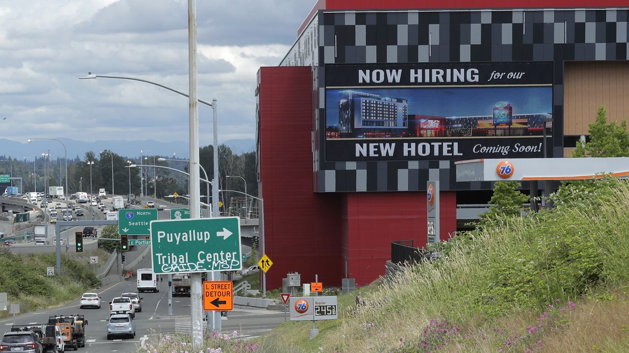 FILE - In this July 9, 2020, file photo, a large video display reads "Now hiring for our new hotel coming soon!," at the new Emerald Queen Casino, which is open, and owned by the Puyallup Tribe of Indians, in Tacoma, Wash. (AP Photo/Ted S. Warren, File)