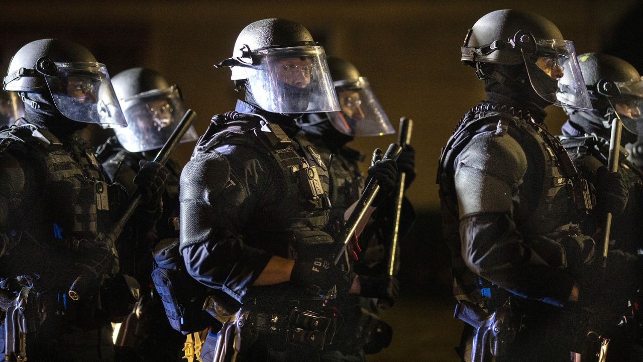 Portland police on Sunday, Aug. 30, 2020 in Portland, Ore. (AP Photo/Paula Bronstein)