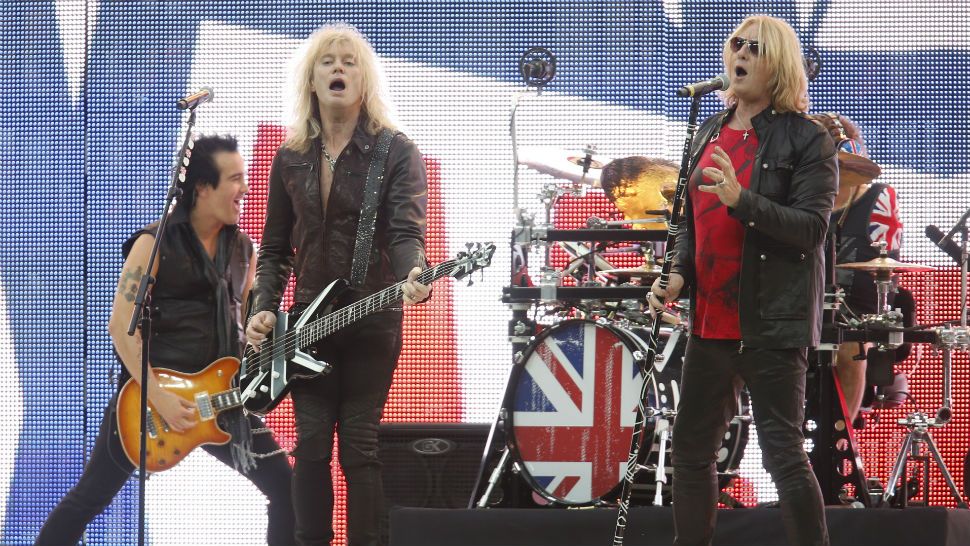 FILE - In this Sept. 28, 2014, file photo, Def Leppard performs before an NFL football game between the Miami Dolphins and the Oakland Raiders, at Wembley Stadium in London. Def Leppard will be the first artist to debut a new music video through the "Guitar Hero" video game. (AP Photo/Lefteris Pitarakis, File)