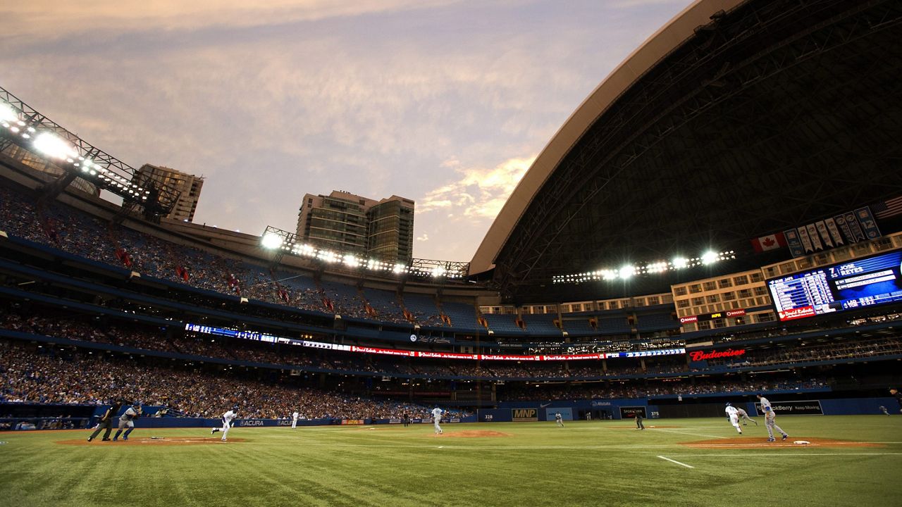 The Toronto Blue Jays play the Los Angeles Dodgers in fourth inning inter-league action under an open dome in Toronto on Monday July 22, 2013. THE CANADIAN PRESS/Frank Gunn