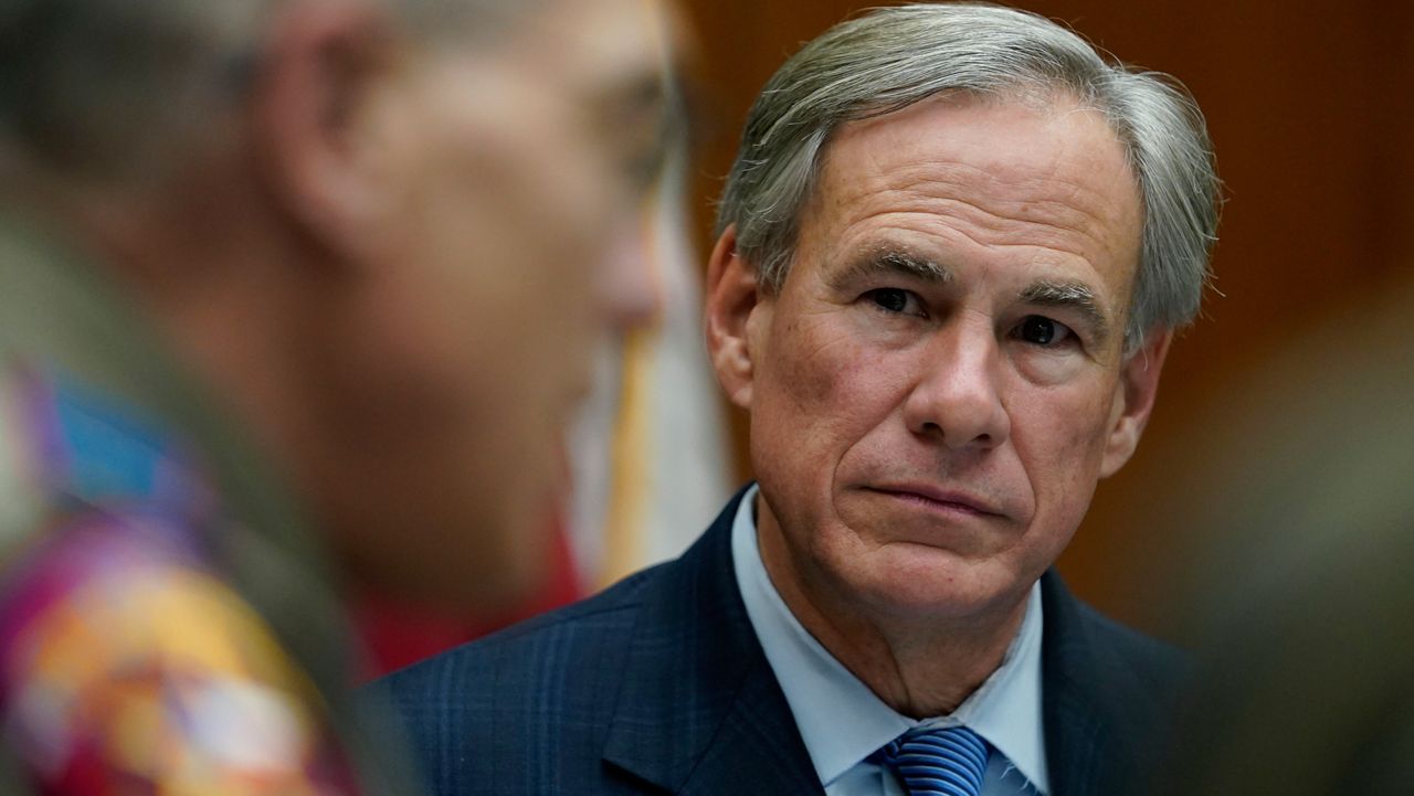 Texas Gov. Greg Abbott, right, takes part in a roundtable discussion on public safety and law enforcement, Thursday, Jan. 21, 2021, in Austin, Texas. 