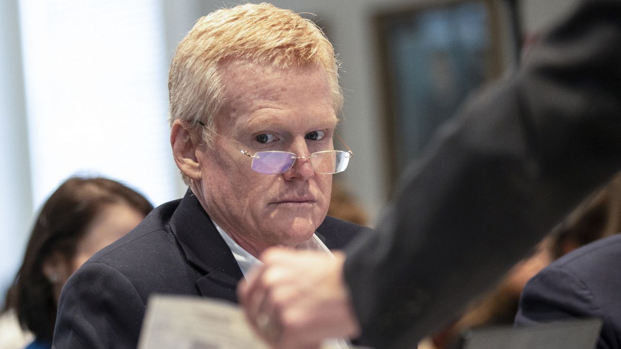 Alex Murdaugh looks over evidence of a check brought to him and his attorneys during his double murder trial at the Colleton County Courthouse on Tuesday, Feb. 7, 2023, in Walterboro, S.C. (Andrew J. Whitaker/The Post And Courier via AP, Pool)/The Post And Courier via AP, Pool)