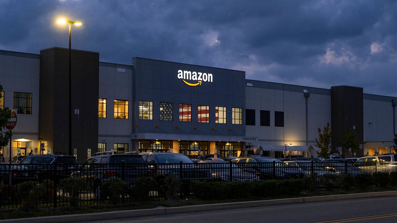 People arrive for work at the Amazon distribution center in the Staten Island borough of New York, Monday, Oct. 25, 2021. (AP Photo/Craig Ruttle)