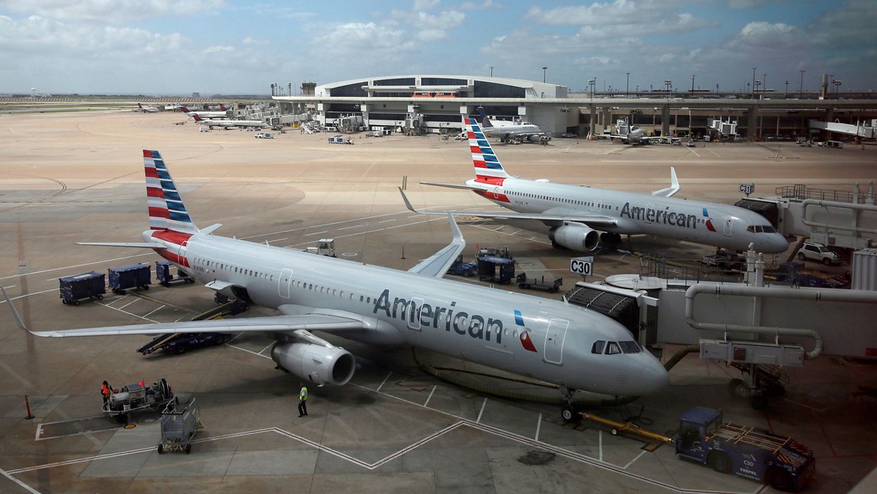 Two American Airlines planes at the gate. (Associated Press)