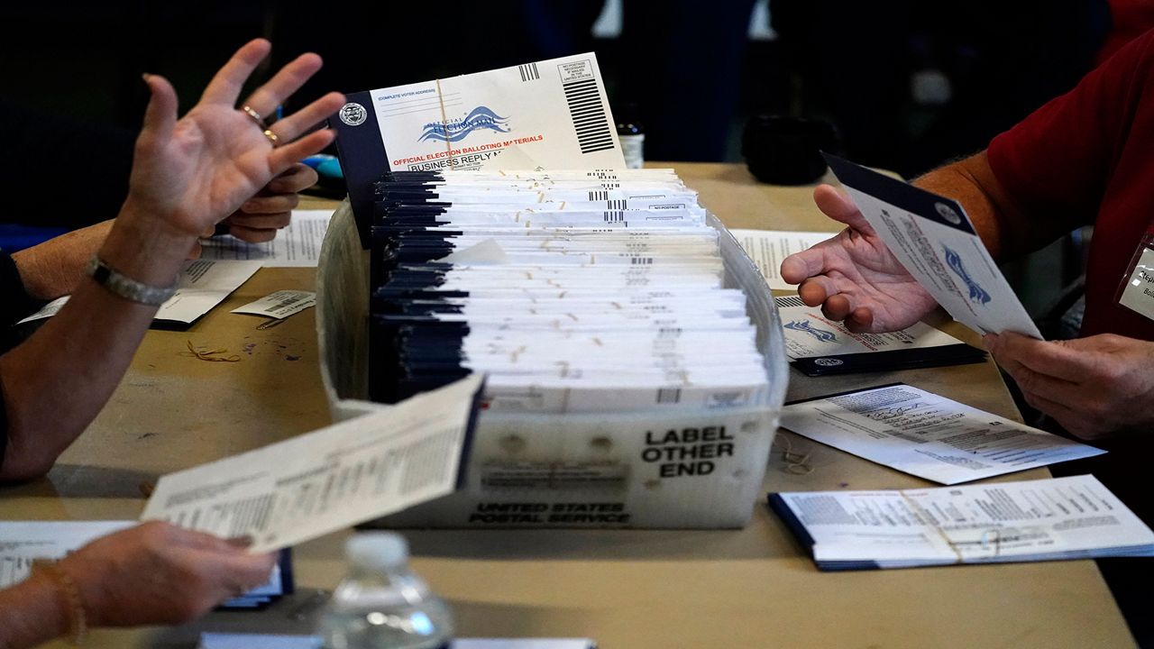 Poll workers counting ballots. 