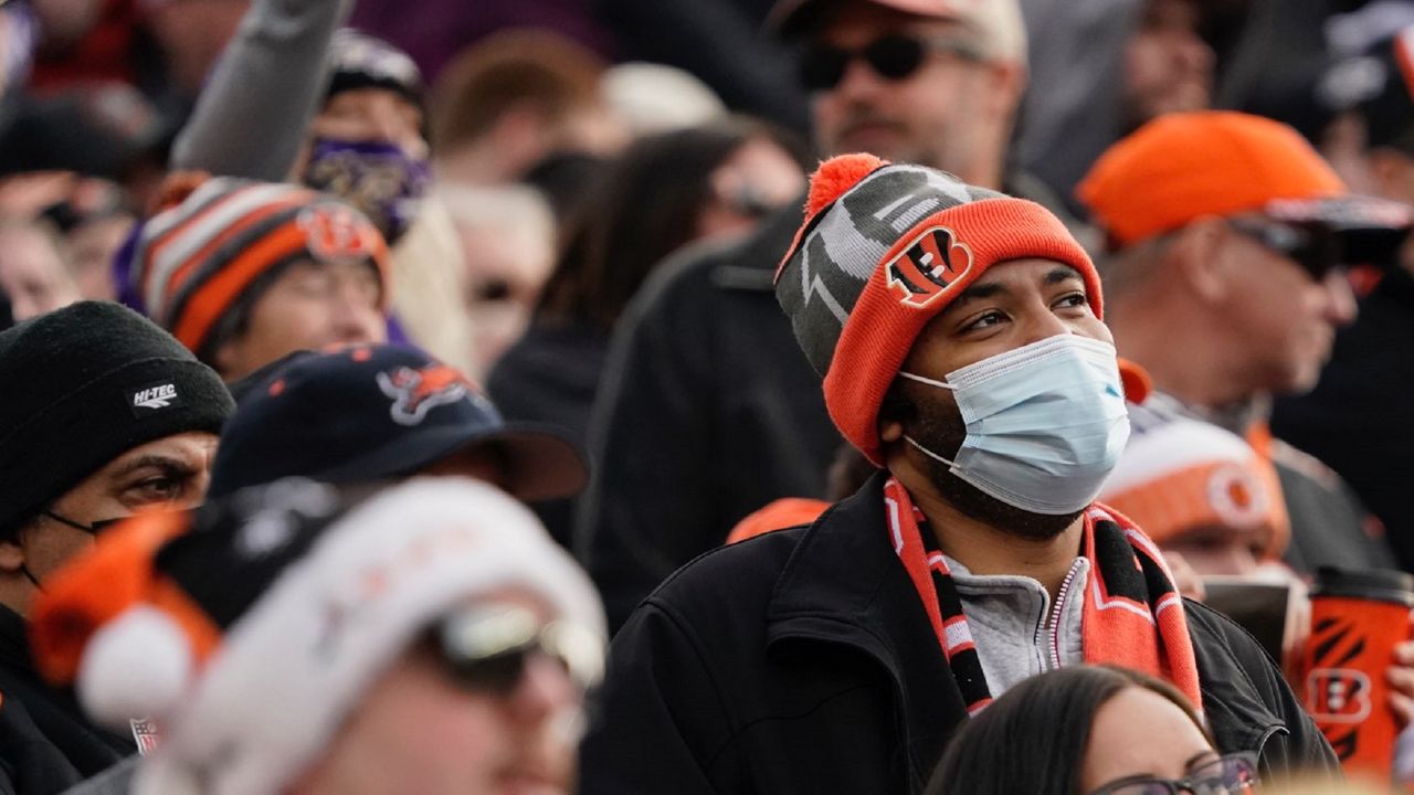 A fan wears a face mask as he watches the second half of an NFL football game between the Cincinnati Bengals and the Baltimore Ravens, Sunday, Dec. 26, 2021, in Cincinnati. (AP Photo/Jeff Dean)