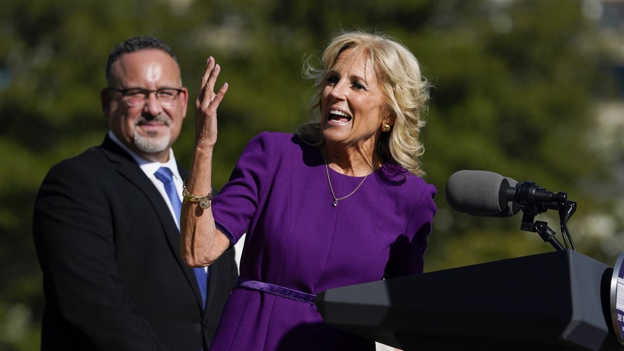 First lady Jill Biden speaks at an event to honor the 2021 State and National Teachers of the Year, on the South Lawn of the White House, Monday, Oct. 18, 2021, in Washington, as Education Secretary Miguel Cardona listens. (AP Photo/Evan Vucci)
