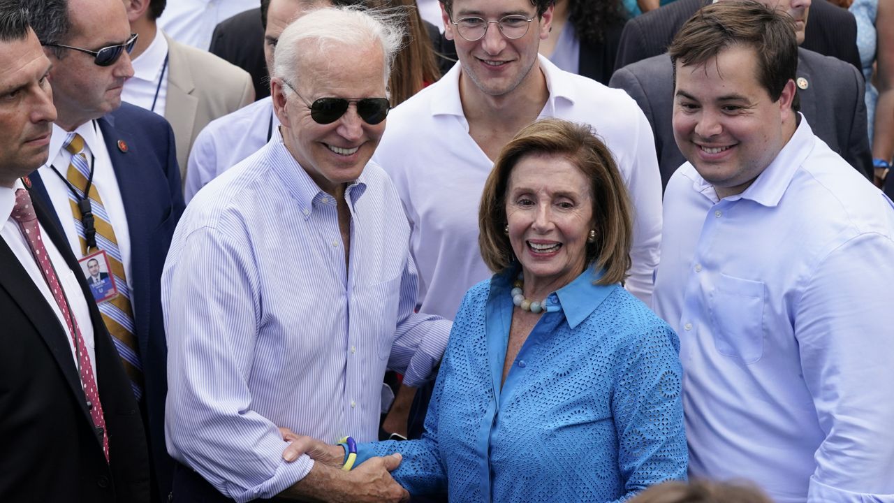 President Joe Biden poses for a photo with House Speaker Nancy Pelosi of Calif., during the Congressional Picnic on the South Lawn of the White House, Tuesday, July 12, 2022, in Washington. (AP Photo/Patrick Semansky)