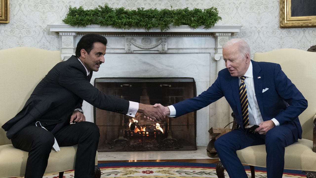 President Joe Biden, right, shakes hands with the Qatar's Emir Sheikh Tamim bin Hamad Al Thani in the Oval Office of the White House, Monday, Jan. 31, 2022, in Washington. (AP Photo/Alex Brandon)