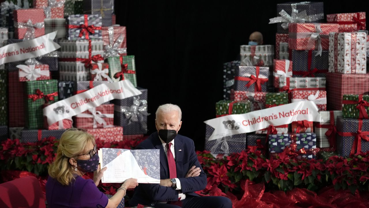 First lady Jill Biden, accompanied by President Joe Biden, reads "The Snowy Day" by Ezra Jack Keats at Children's National Hospital in Washington, Friday, Dec. 23, 2022. (AP Photo/Andrew Harnik)