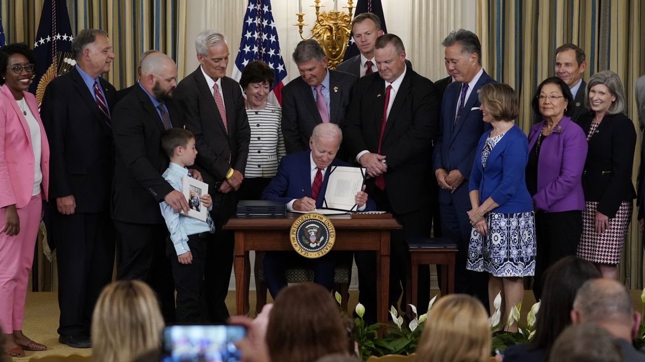 President Joe Biden signs into law nine bipartisan bills that will honor and improve care for America's veterans during an event in the State Dining Room of the White House in Washington, Tuesday, June 7, 2022. (AP Photo/Susan Walsh)