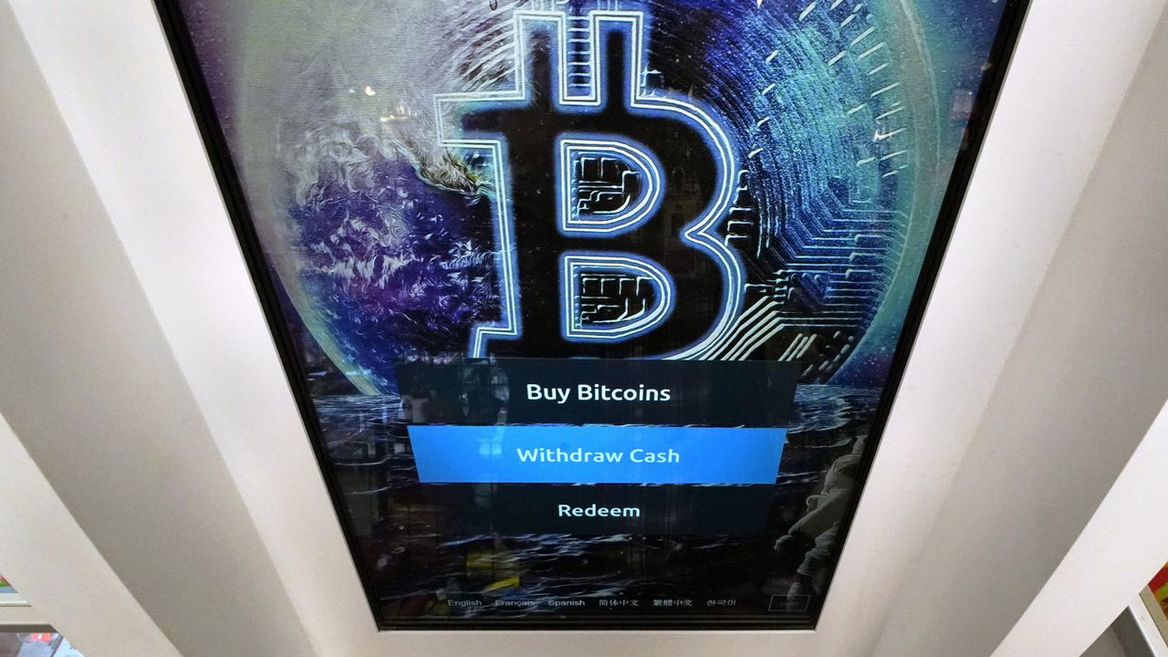 FILE - In this Feb. 9, 2021, file photo, the Bitcoin logo appears on the display screen of a cryptocurrency ATM in Salem, N.H. (AP Photo/Charles Krupa, File)