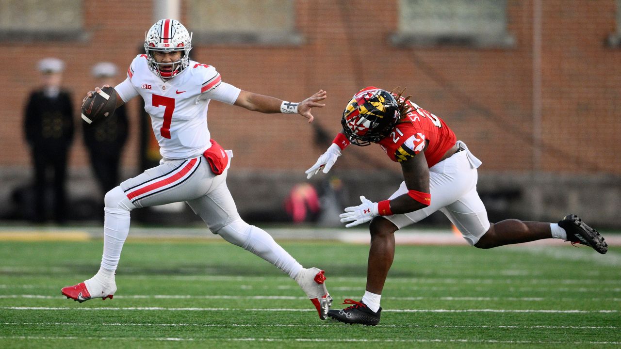 Ohio State quarterback C.J. Stroud (7) scrambles past Maryland linebacker Gereme Spraggins in the first half on Saturday, Nov. 19, 2022, in College Park, Md. (AP Photo/Nick Wass)