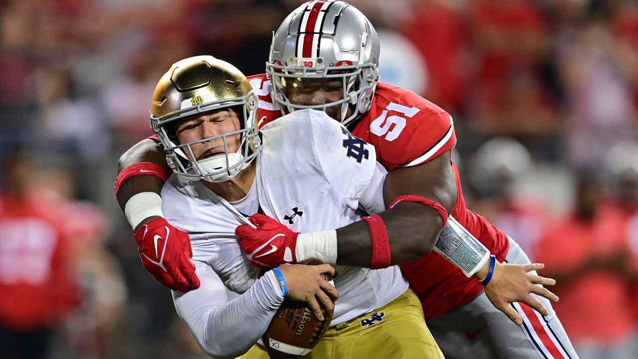 Notre Dame quarterback Tyler Buchner is sacked by Ohio State defensive tackle Michael Hall Jr. in the fourth quarter. (AP Photo/David Dermer)