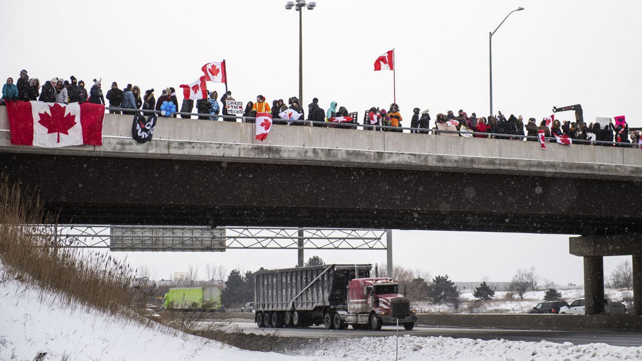 FILE: Protestors show their support for the Freedom Convoy of truck drivers who are making their way to Ottawa to protest against COVID-19 vaccine mandates by the Canadian government on Thursday, Jan. 27, 2022, in Vaughan. (Photo by Arthur Mola/Invision/AP)
