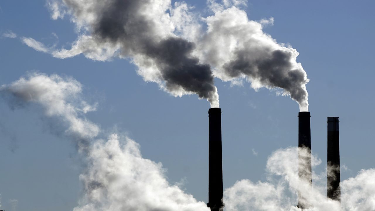 Steam is emitted from smoke stacks at a coal-fired power plant Nov. 17, 2021, in Craig, Colo. (AP Photo/Rick Bowmer, File)