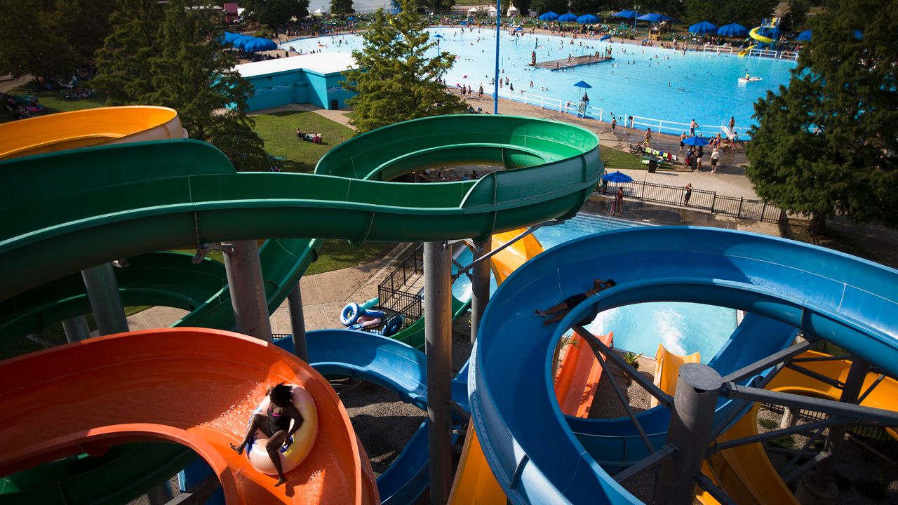 Children ride The Twister water slide at Coney Island amusement park, Sunday, Aug. 30, 2015, in Cincinnati. (AP Photo/John Minchillo)