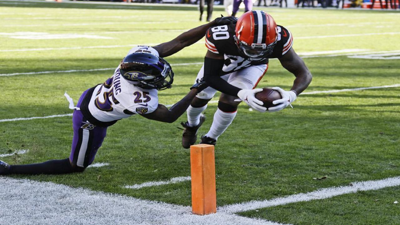 Cleveland Browns wide receiver Jarvis Landry (80) scores a 9-yard touchdown as Baltimore Ravens cornerback Tavon Young (25) defends during the first half of an NFL football game, Sunday, Dec. 12, 2021, in Cleveland. (AP Photo/Ron Schwane)