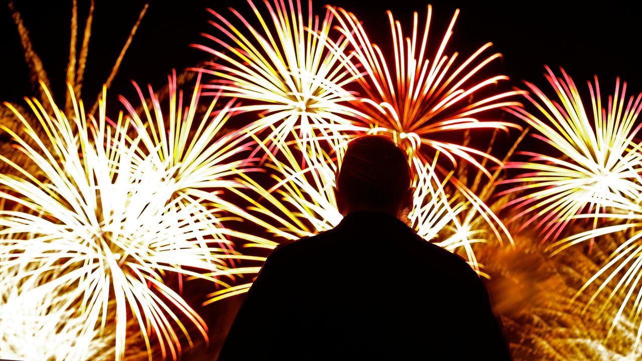 A man watches fireworks after a baseball game between the Kansas City Royals and the Cleveland Indians on Wednesday, July 3, 2019