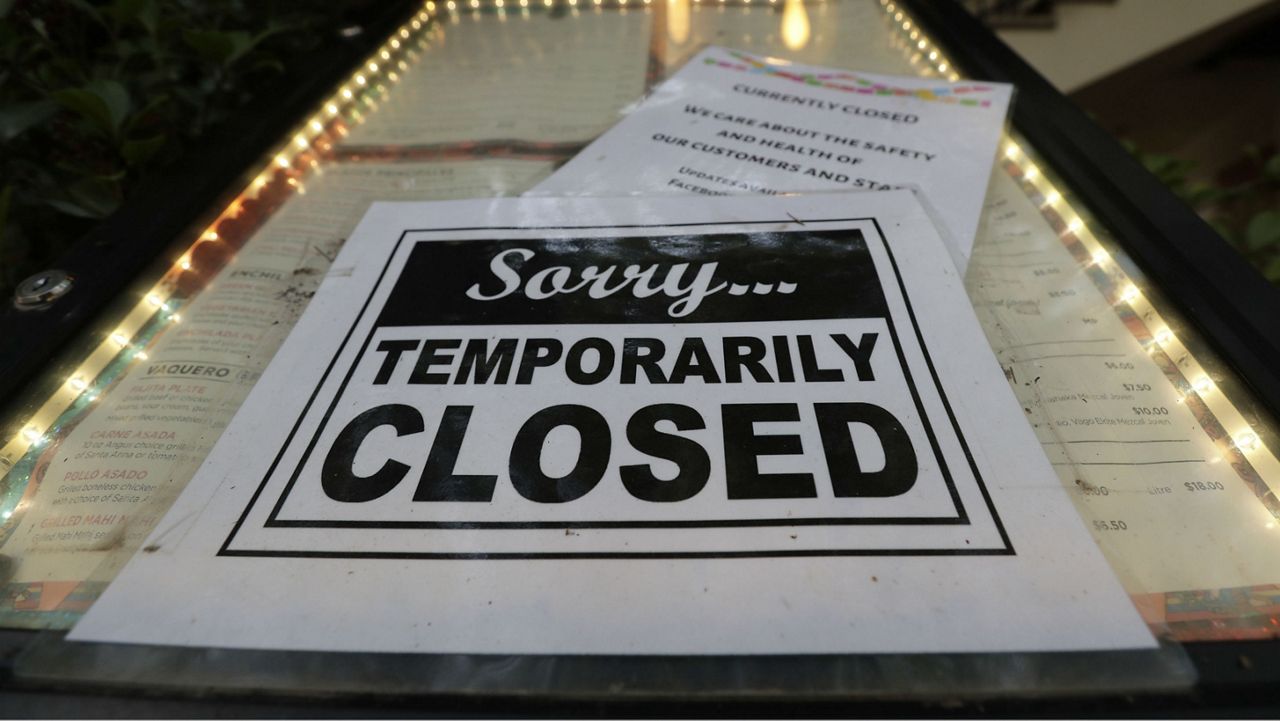 A restaurant displays a "temporarily closed" sign. (AP file)