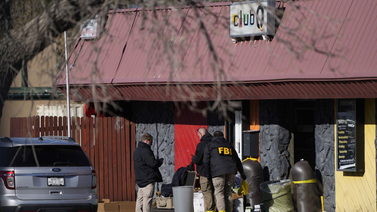 Law enforcement investigators exit Club Q, the site of a weekend mass shooting, on Tuesday, Nov. 22, 2022, in Colorado Springs, Colo. (AP Photo/David Zalubowski)