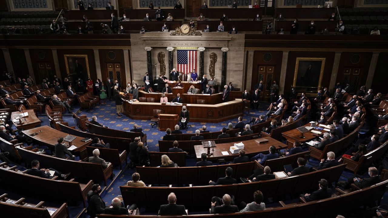FILE - This Jan. 6, 2021, photo shows the House chamber as Speaker of the House Nancy Pelosi, D-Calif., and Vice President Mike Pence officiate the tally of the Electoral College votes cast in November's election, at the Capitol in Washington. (AP Photo/J. Scott Applewhite, Pool, File)