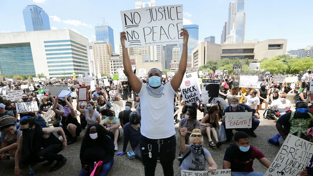 Protesters demonstrate police brutality in front of Dallas City Hall in downtown Dallas, Saturday, May 30, 2020. Protests across the country have escalated over the death of George Floyd who died after being restrained by Minneapolis police officers on Memorial Day. (AP Photo/LM Otero)