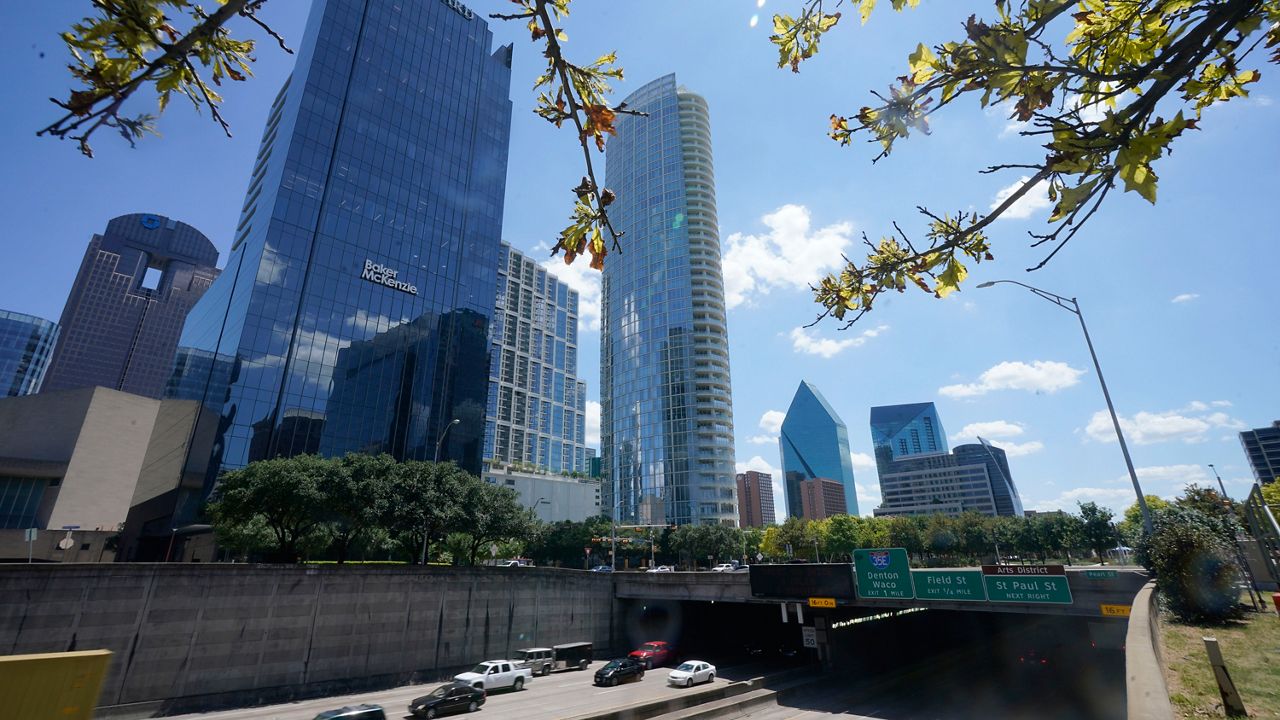 Light afternoon traffic flows in downtown Dallas, Thursday, Aug. 12, 2021. (AP Photo/LM Otero)