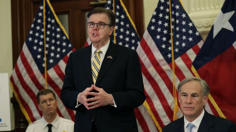 Lt. Gov. Dan Patrick, center, stands next to Texas Gov. Greg Abbott, right, during a news conference where the governor announced he would relax some restrictions imposed on businesses due to the COVID-19 pandemic, Monday, April 27, 2020, in Austin, Texas. (AP Photo/Eric Gay)