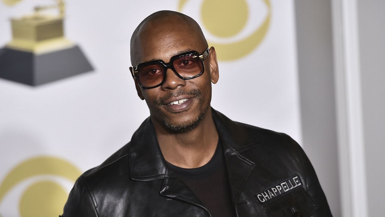 FILE - In this Jan. 28, 2018 file photo, Dave Chappelle poses in the press room with the best comedy album award for "The Age of Spin" and "Deep in the Heart of Texas" at the 60th annual Grammy Awards in New York. Chappelle celebrated George Floyd’s life and ripped the media for the way it handled his death in a surprise Netflix special. (Photo by Charles Sykes/Invision/AP, File)