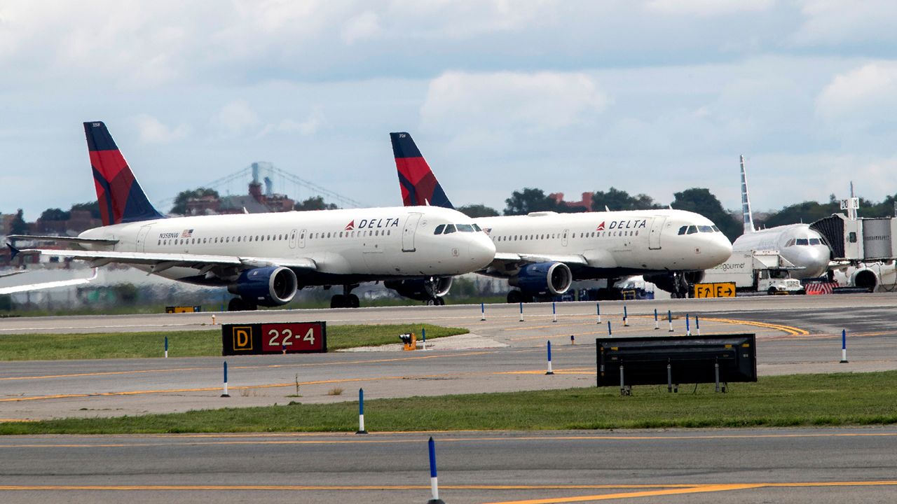 In this Aug. 8, 2017 file photo, Delta Air Lines airplanes line the tarmac ahead of a groundbreaking ceremony of the construction on Delta Air Lines $4 billion, 37-gate facility at LaGuardia Airport, in the Queens borough of New York. A technical outage is impacting major airlines and causing flight delays that may lead to a ripple effect throughout the day. The Federal Aviation Administration said Monday, April 1 that several airlines were dealing with computer issues. The agency recommended people contact their airline directly for flight information and updates. There are some delays already at airports in Chicago, New York, Boston, Atlanta, Miami and Detroit. Delta said some of its flights were impacted. (AP Photo/Mary Altaffer, File)