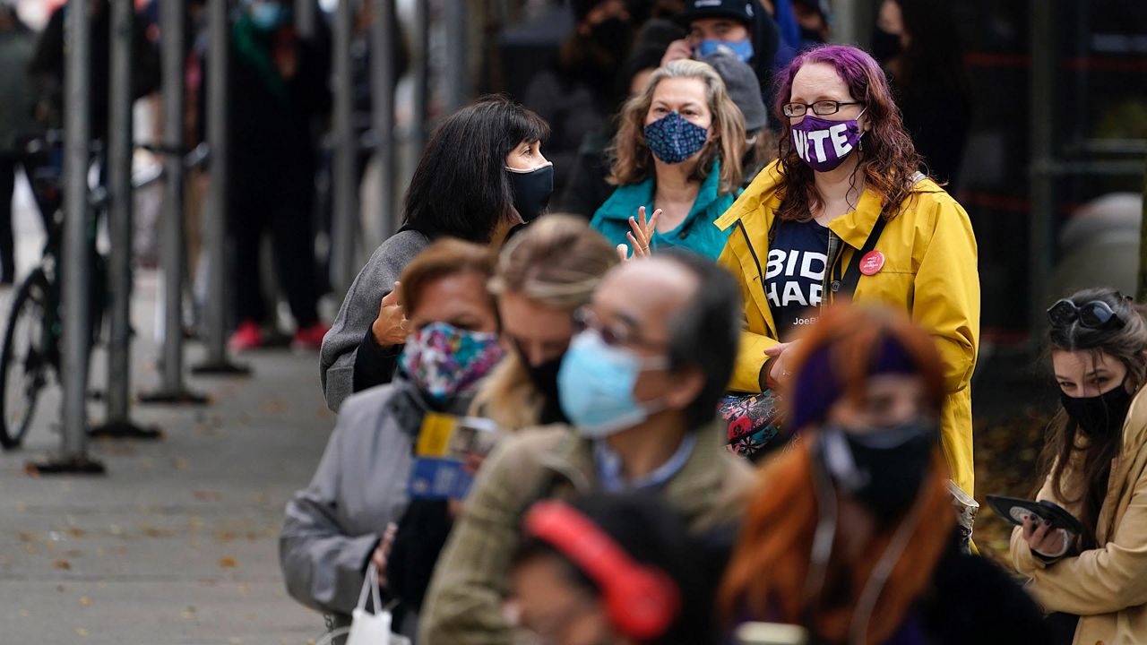 people wait in New York outside an early voting poll site