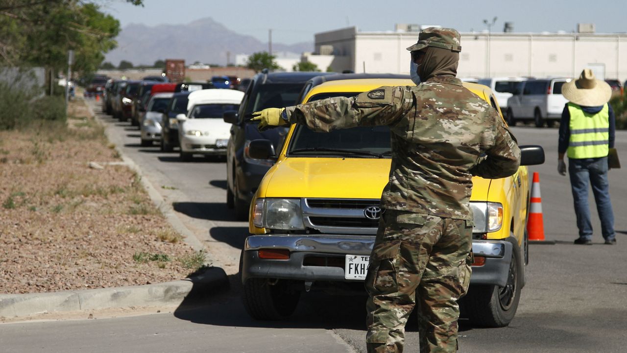 FILE - Vehicles with residents waiting to be tested for COVID-19 are directed in El Paso, Texas. (Associated Press)