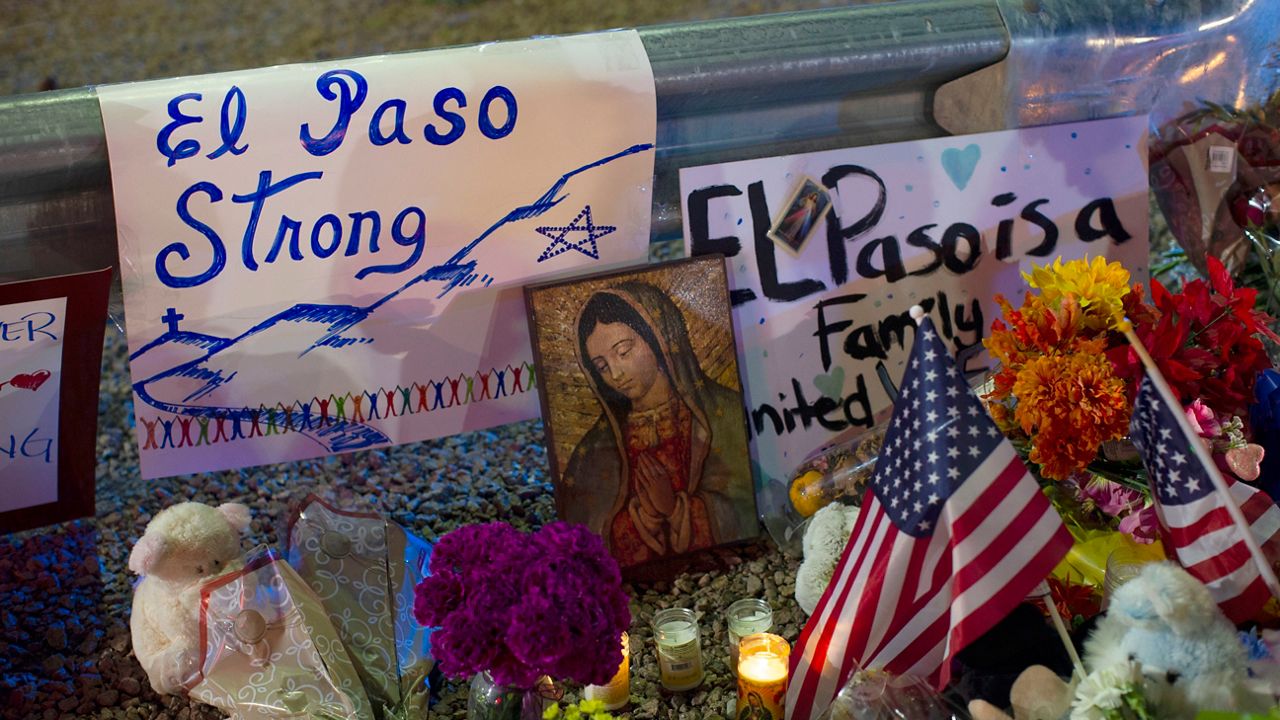 In this Aug. 4, 2019 file photo, a Virgin Mary painting, flags and flowers adorn a makeshift memorial for the victims of the mass shooting at a Walmart in El Paso, Texas. (AP Photo/Andres Leighton, File)