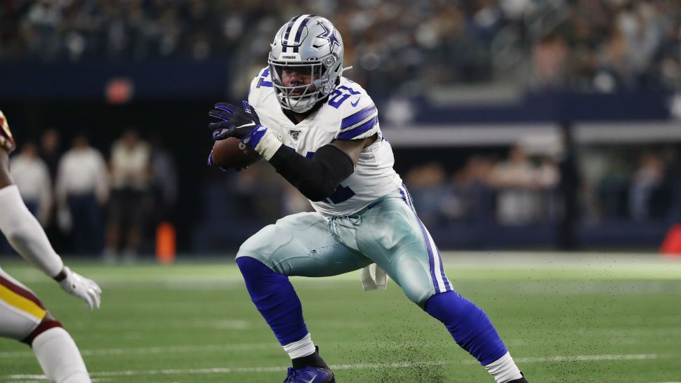 In this Aug. 9, 2018, file photo, Dallas Cowboys running back Ezekiel  Elliott (21) smiles as he runs off the field after the first half of an NFL  preseason football game against