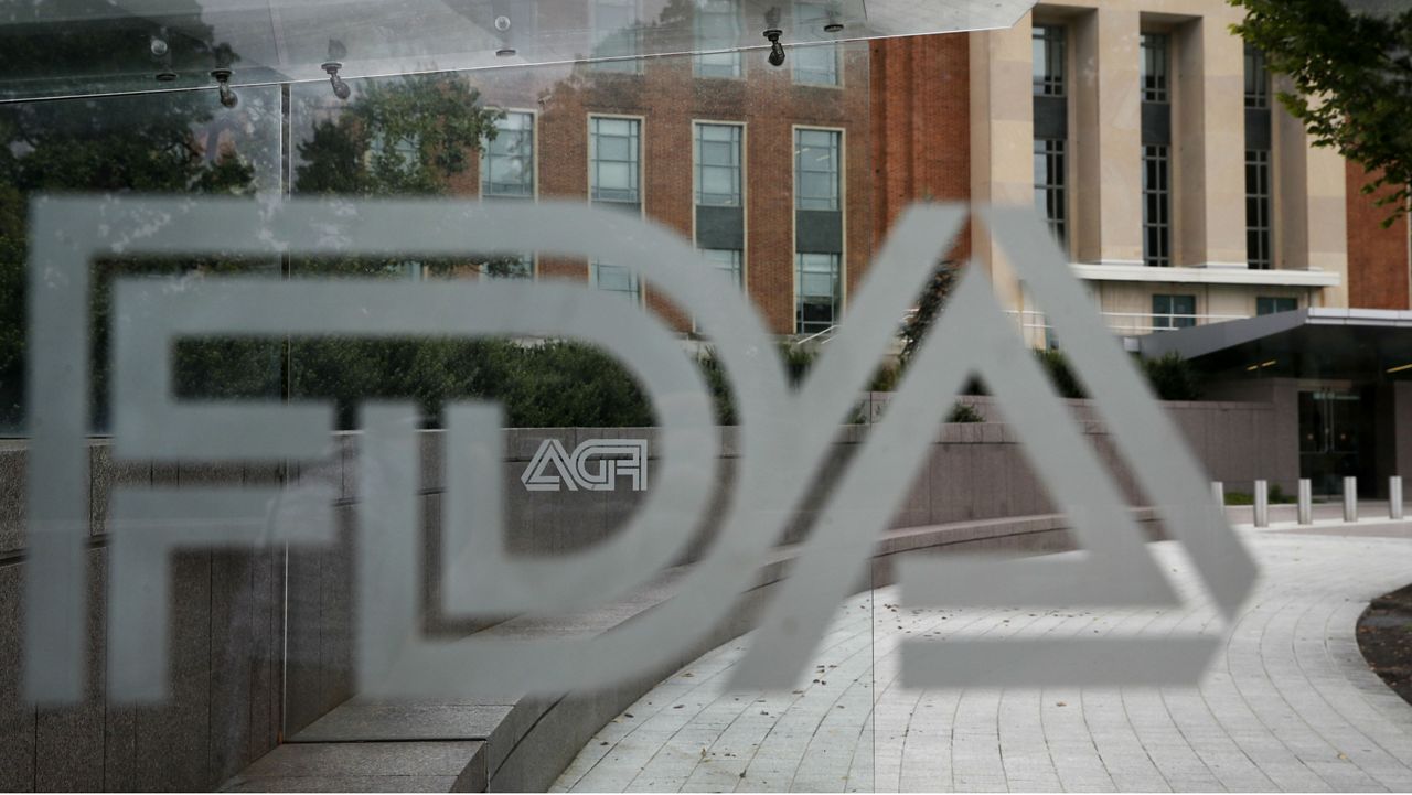 This 2018 file photo shows the Food and Drug Administration building behind FDA logos at a bus stop on the agency's campus in Silver Spring, Md. (AP Photo/Jacquelyn Martin, File)