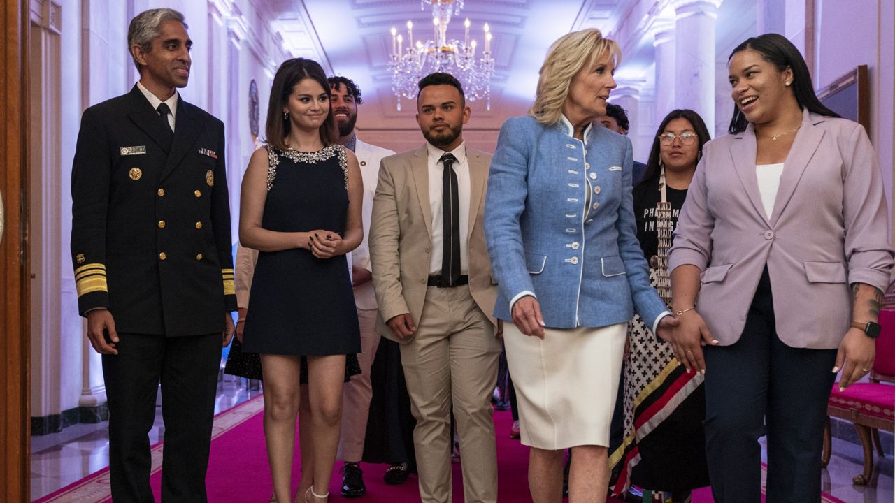 First lady Jill Biden holds hands with youth mental health advocate Ayanna Kelly, right, as they arrive to the White House Conversation on Youth Mental Health Wednesday, May 18, 2022. (AP Photo/Jacquelyn Martin)
