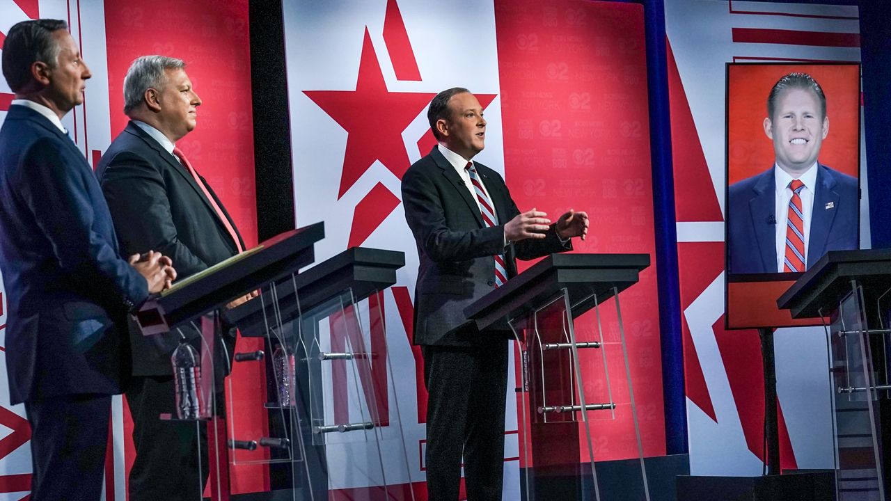 Former Westchester County Executive Rob Astorino, far left, businessman Harry Wilson, second from left, Suffolk County Congressman Lee Zeldin, second from right, and Andrew Giuliani, far right, son of former New York City Mayor Rudy Giuliani, face off during New York's Republican gubernatorial debate at the studios of CBS2 TV, Monday, June 13, 2022, in New York. Giuliani participated via virtual broadcast after he was blocked from the studios for not meeting vaccine requirements. (AP Photo/Bebeto Matthews)