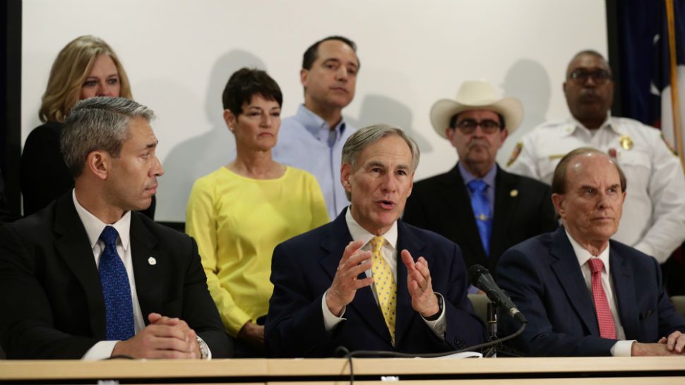 Texas Gov. Greg Abbott, center, is joined by San Antonio Mayor Ron Nirenberg , left, and other state and city officials as he gives an update on the coronavirus outbreak, Monday, March 16, 2020, in San Antonio. (AP Photo/Eric Gay)