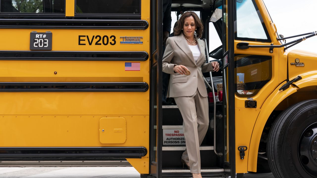 Vice President Kamala Harris walks off of an electric school bus during a tour at Meridian High School, in Falls Church, Va., Friday, May 20, 2022. (AP Photo/Jacquelyn Martin)